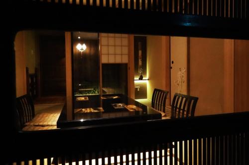 a view of a room with two chairs and a table at Kyomachiya Ebisu Private Luxury Townhouse in Higashiyama in Kyoto