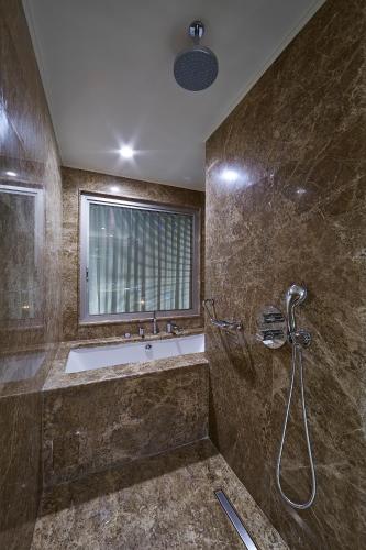 a bathroom with a tub and a sink and a window at Uranus Istanbul Topkapi in Istanbul