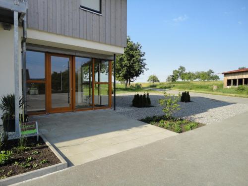 a building with glass doors on the side of it at Gasthof Reiterstuben in Hoßkirch