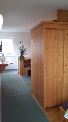a room with a wooden cabinet and a couch at Apartment Kaprun in Niedernsill