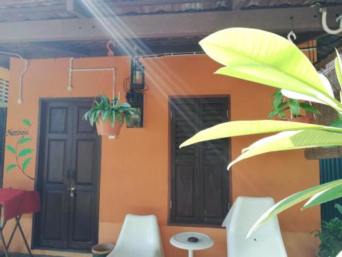 a house with two doors and plants in front of it at Coco Country Homes in Melaka