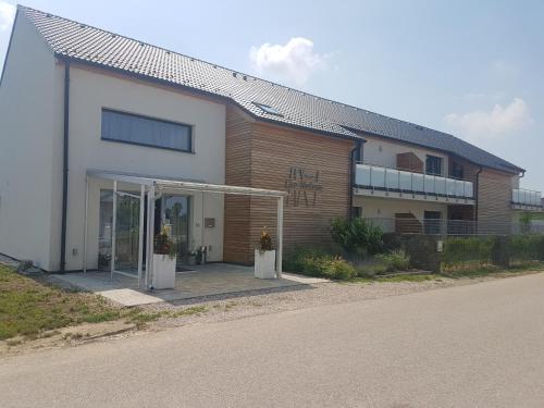 a building with an open door next to a street at Pension Laa Natura in Laa an der Thaya