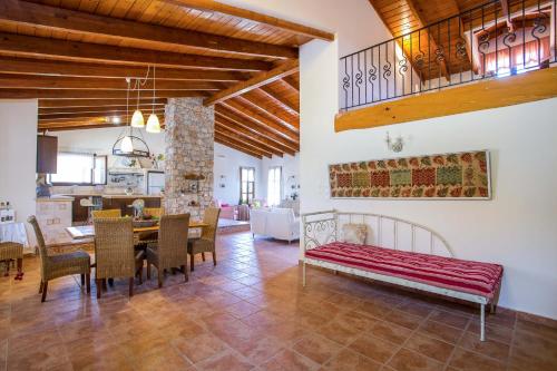 a kitchen and dining room with a table and chairs at Sunny Countryside Villa - With private pool in Faliraki