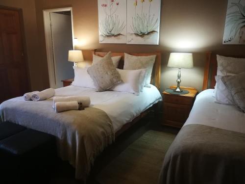 a bedroom with two beds with towels on the bed at Augrabies Falls Lodge & Camp in Augrabies