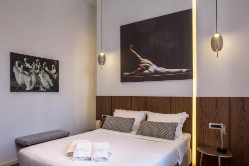 a bedroom with a bed with two towels on it at Gambello Luxury Rooms in Nafplio