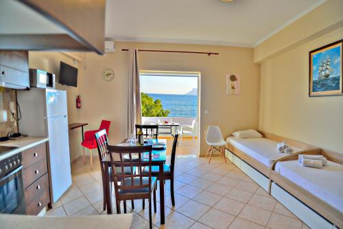 a room with a kitchen and a living room at Beach House in Kissamos
