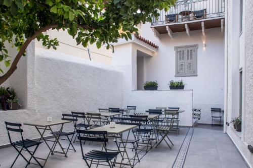 a row of tables and chairs in a patio at Gambello Luxury Rooms in Nafplio