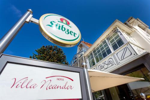a sign in front of a building with a walka needer sign at Hotel Villa Neander in Binz