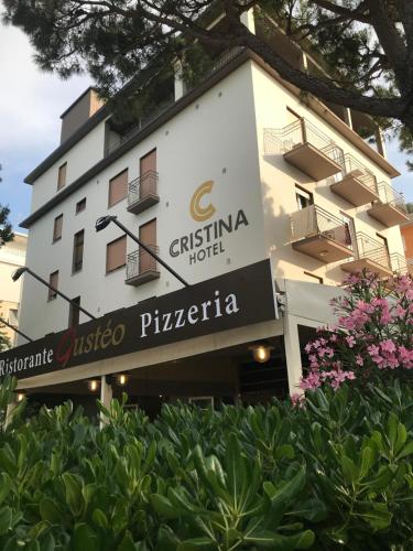 a building with a sign for a hotel at Hotel Cristina in Lido di Jesolo