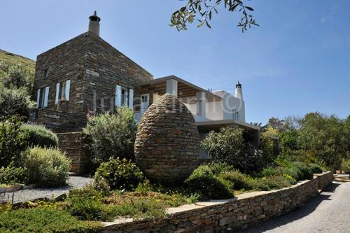 a house with a large stone sculpture in front of it at Red Tractor Farm in Korissia