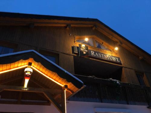 a restaurant sign on the side of a building at Pension Raststüb'l in Sorge