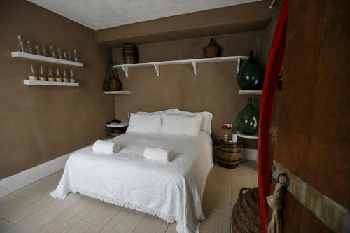 a bedroom with a bed with white sheets and pillows at La Pampa Relais & Spa in Melizzano