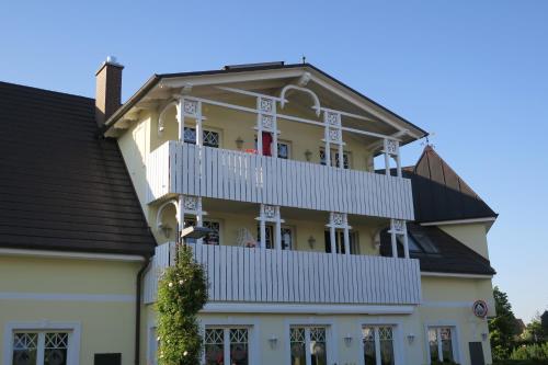 a large white building with a balcony at Julia in Zingst