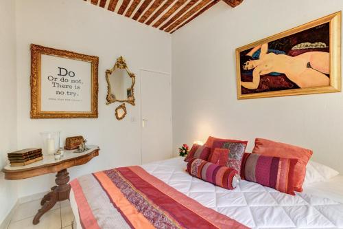 a bedroom with a bed and a painting on the wall at Cocoon'in Cannes Le Suquet in Cannes