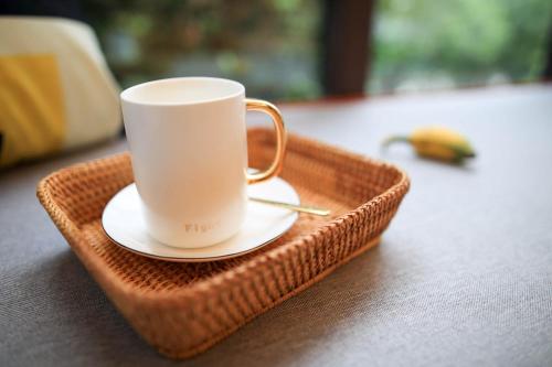 a coffee cup sitting on a tray on a table at Li River Resort Villa Hotel in Guilin
