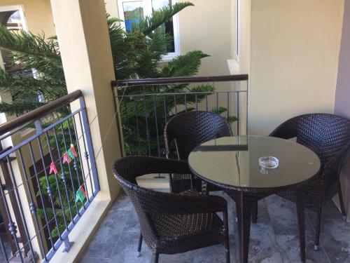 a patio with a table and chairs on a balcony at Villa Narmada in Grand Baie