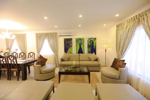 a living room with a couch and a table at Laya Leisure Resort & Spa in Kalawana
