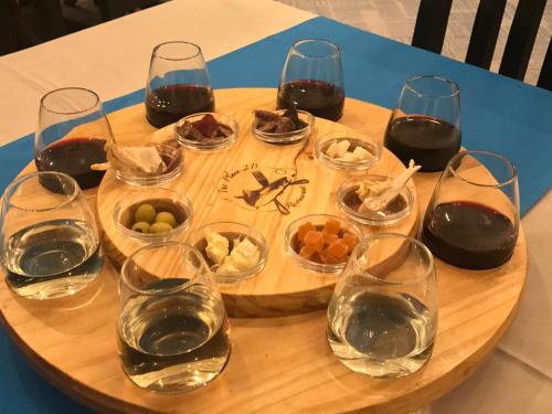 a wooden table topped with glasses of wine and snacks at Lanseria Country Estate in Lanseria
