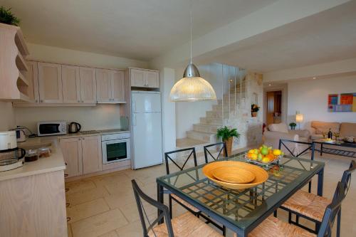 a kitchen and living room with a table and chairs at Ideales Resort in Trapezaki