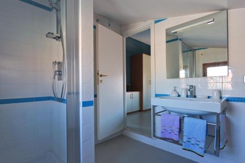 a bathroom with a sink and a mirror at La Perla Del Tirreno in Santa Severa