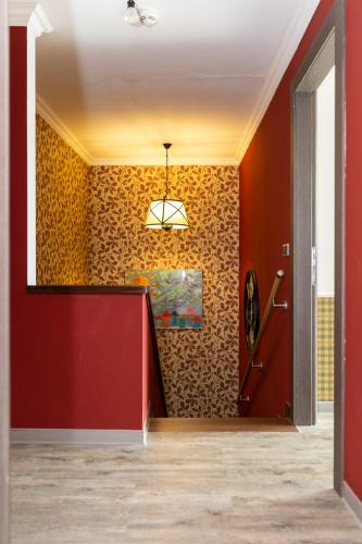 a hallway with orange walls and a red wall at Silver Mountain 3 Bedroom Apartment in Poiana Brasov