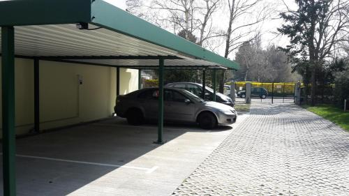 a car parked in a parking lot next to a building at Hotel Strebersdorferhof in Vienna