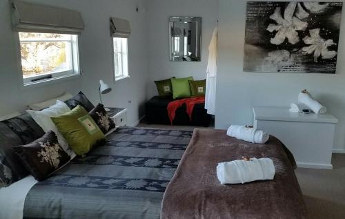 a bedroom with a bed with two towels on it at 210 Hillsidecottage in Nelson