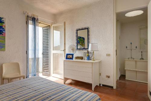 a bedroom with a bed and a dresser and a mirror at Terrazza Marina in Porto Santo Stefano