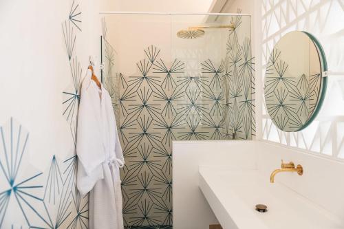 a bathroom with a tub and a sink and a mirror at Boutique Hotel Villa Gala by Fimedhotels in Cadaqués