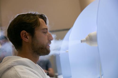 a man with a beard sitting in a hair salon at Hotel Terme Venezia in Abano Terme