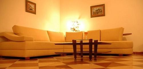 a living room with a couch and a coffee table at Dynasty Suite in Aley