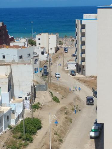 an aerial view of a city with the ocean at Oued Laou Apartment in Oued Laou