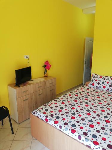 a bedroom with a bed and a tv on a cabinet at Smeštaj - sobe MARVEL in Niš