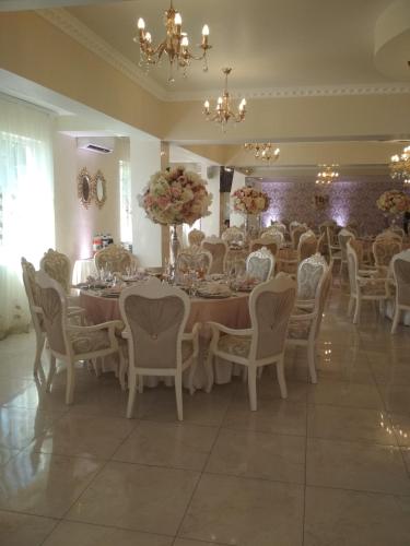a dining room with a long table and chairs at Hotel Elita in Odesa