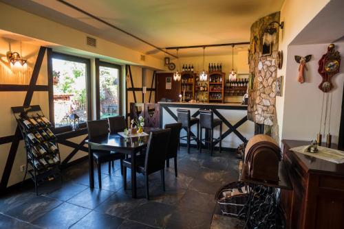 a restaurant with a table and chairs and a bar at Raad na Uroczysku in Szklarska Poręba