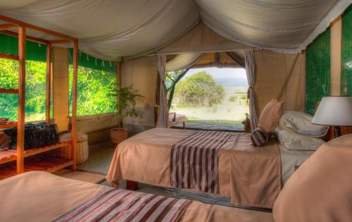 Voodi või voodid majutusasutuse Losokwan Luxury Tented Camp - Maasai Mara toas