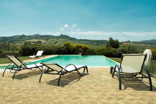two lounge chairs and a swimming pool in a yard at Agriturismo San Marcello in Castiglione dʼOrcia