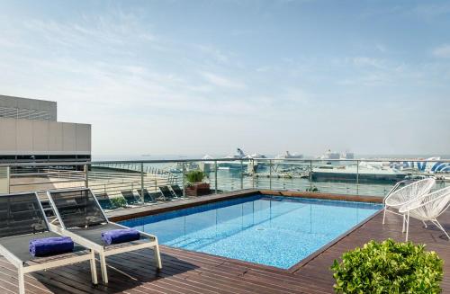a swimming pool on the roof of a building at Eurostars Grand Marina Hotel GL in Barcelona