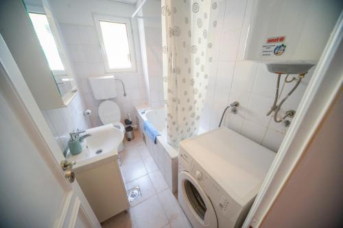 ein kleines Bad mit einer Waschmaschine in der Unterkunft City In Apartment in Kotor