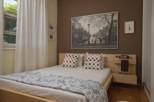 a bedroom with a bed and a picture on the wall at Seaside Cottage in Paralia Katerinis