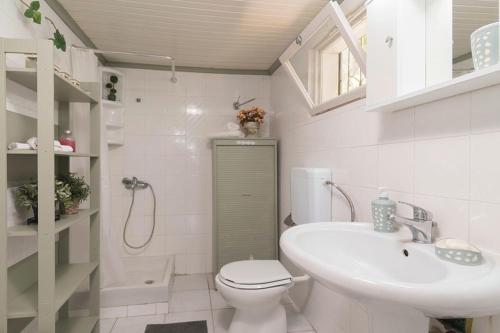 a bathroom with a toilet and a sink at Seaside Cottage in Paralia Katerinis