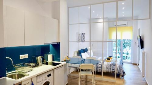 a kitchen with a table and a bed in a room at Charming Sunny Studio in Athens in Athens