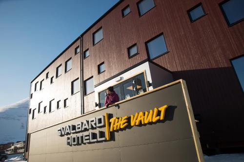 a building with a sign on the side of it at Svalbard Hotell | The Vault in Longyearbyen