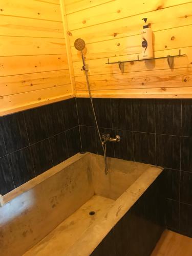 a bath tub in a room with a wooden ceiling at Country Homes in Ella