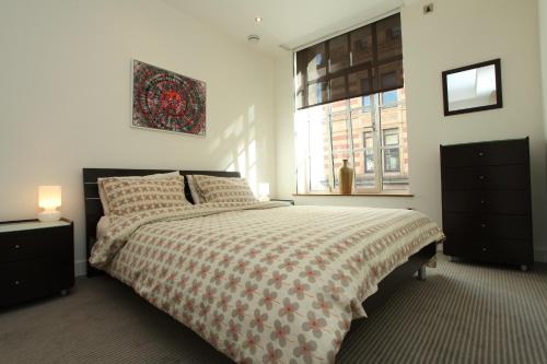 a bedroom with a large bed and a window at Park Row Apartments in Leeds
