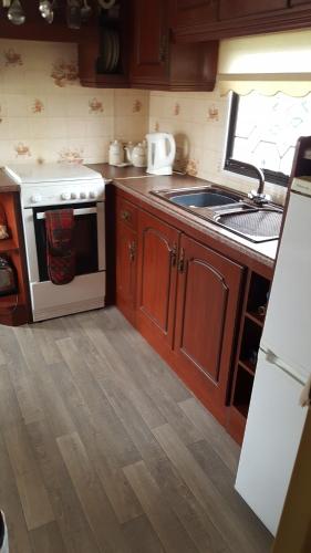 a kitchen with a white stove and a sink at Static caravan in Chapel Saint Leonards