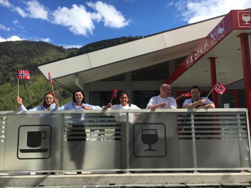 a group of people standing in front of a gas station at Blix Hotel in Vikøyri