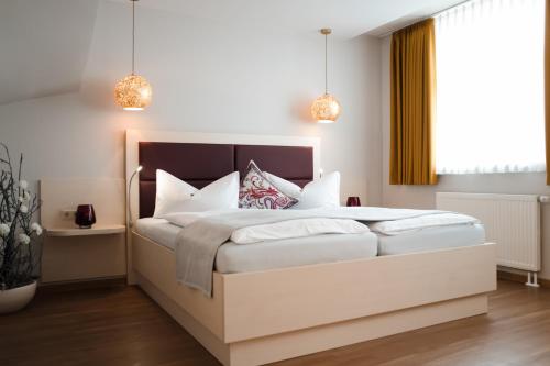 a bedroom with a large white bed with white pillows at Altstadt-Apartment in Freiberg