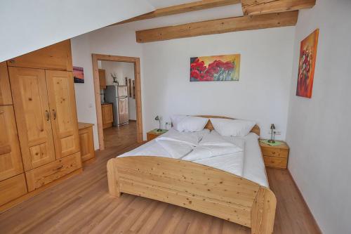 1 dormitorio con 1 cama grande con marco de madera en Ferienhof Schneiderweg, en Laussa