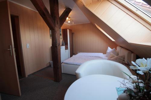 a small room with a bed in a attic at Lindenhof Liepgarten - Pension & Gaststätte in Ueckermünde